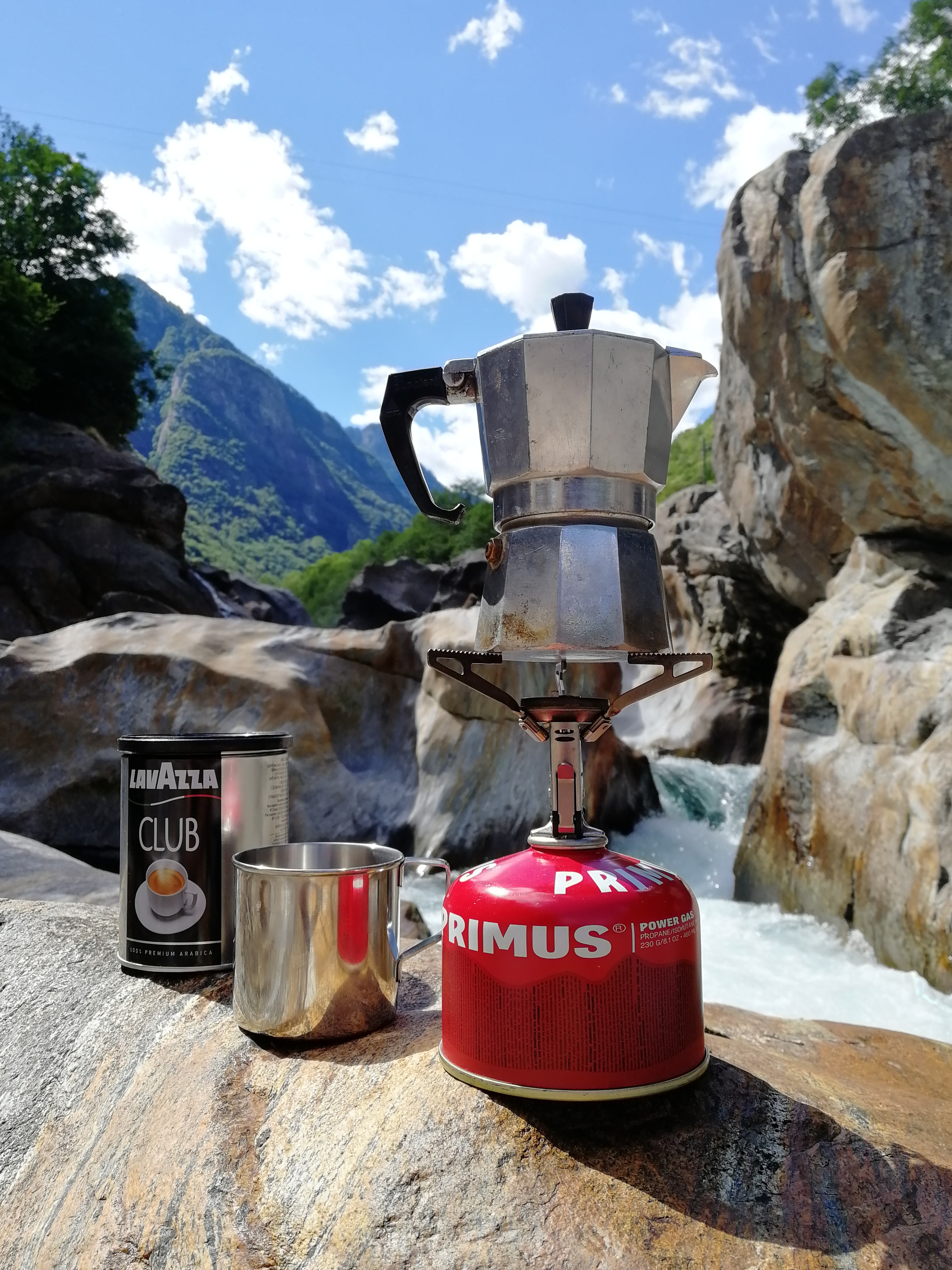 A moka pot on a singular camping stove.